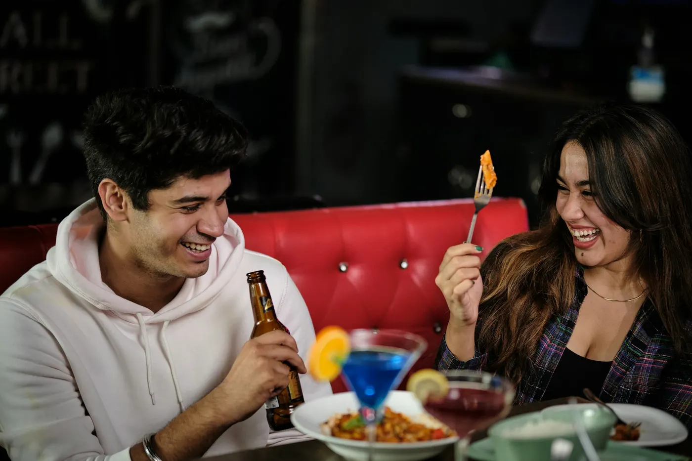 A couple laughing over dinner