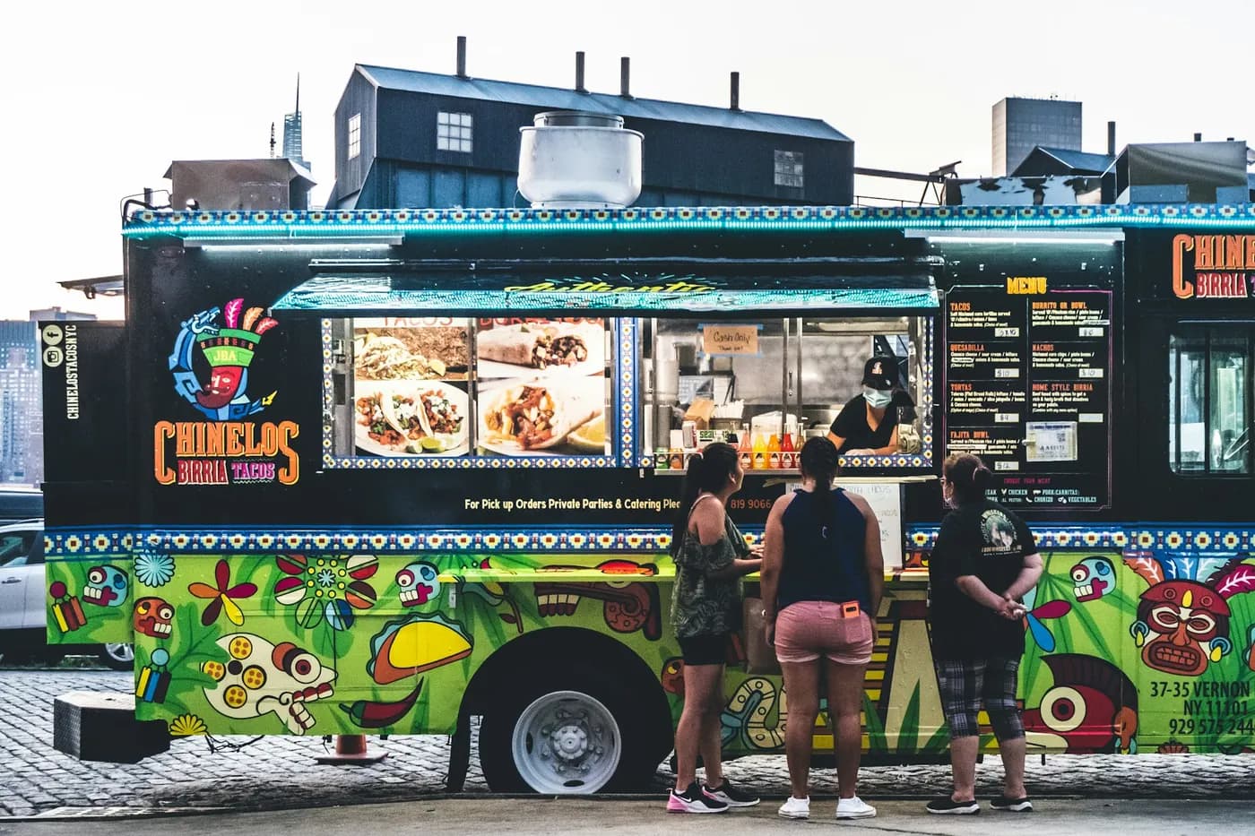 A painted taco truck with a queue